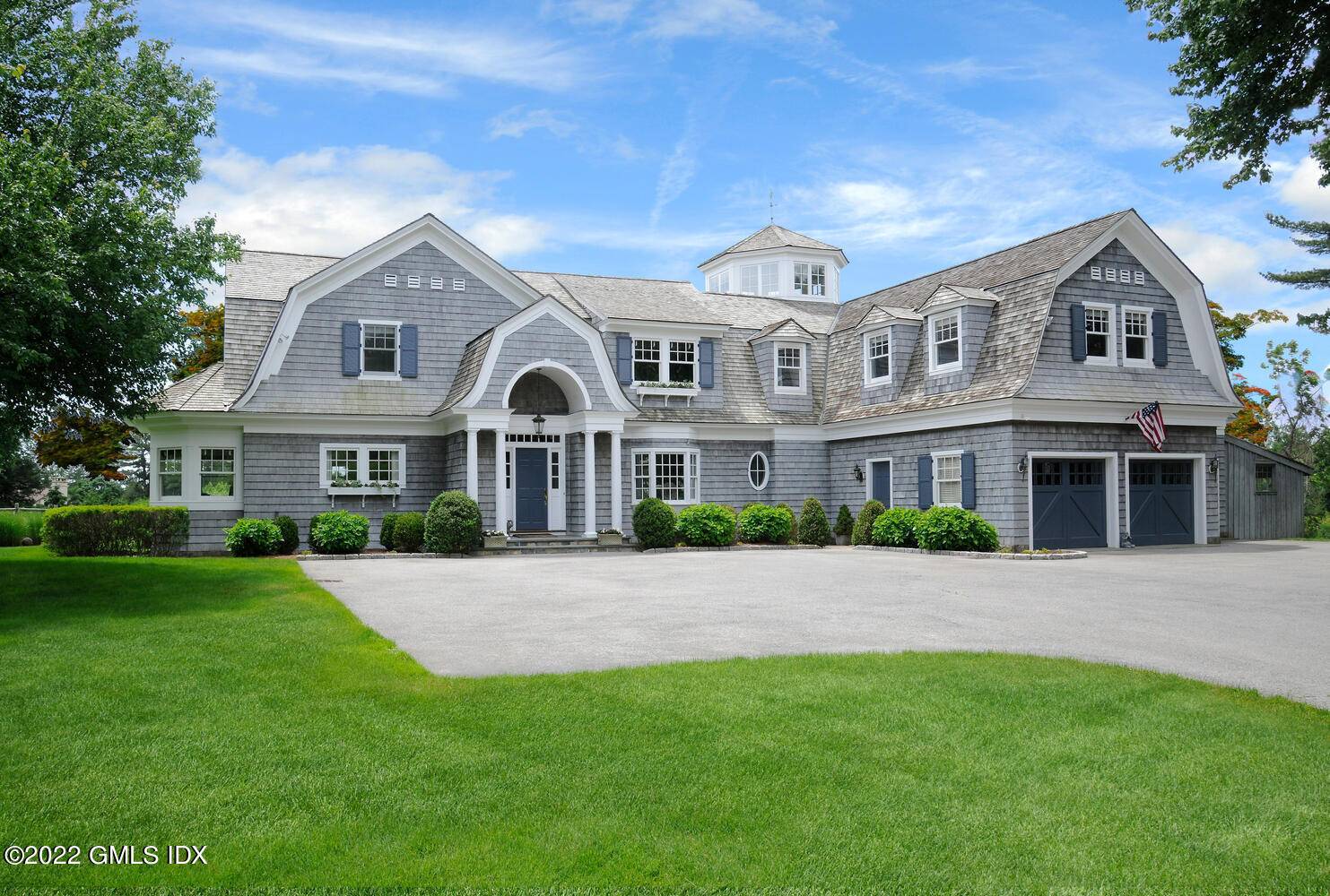 This warm, welcoming light filled shingle style home sits on 2.