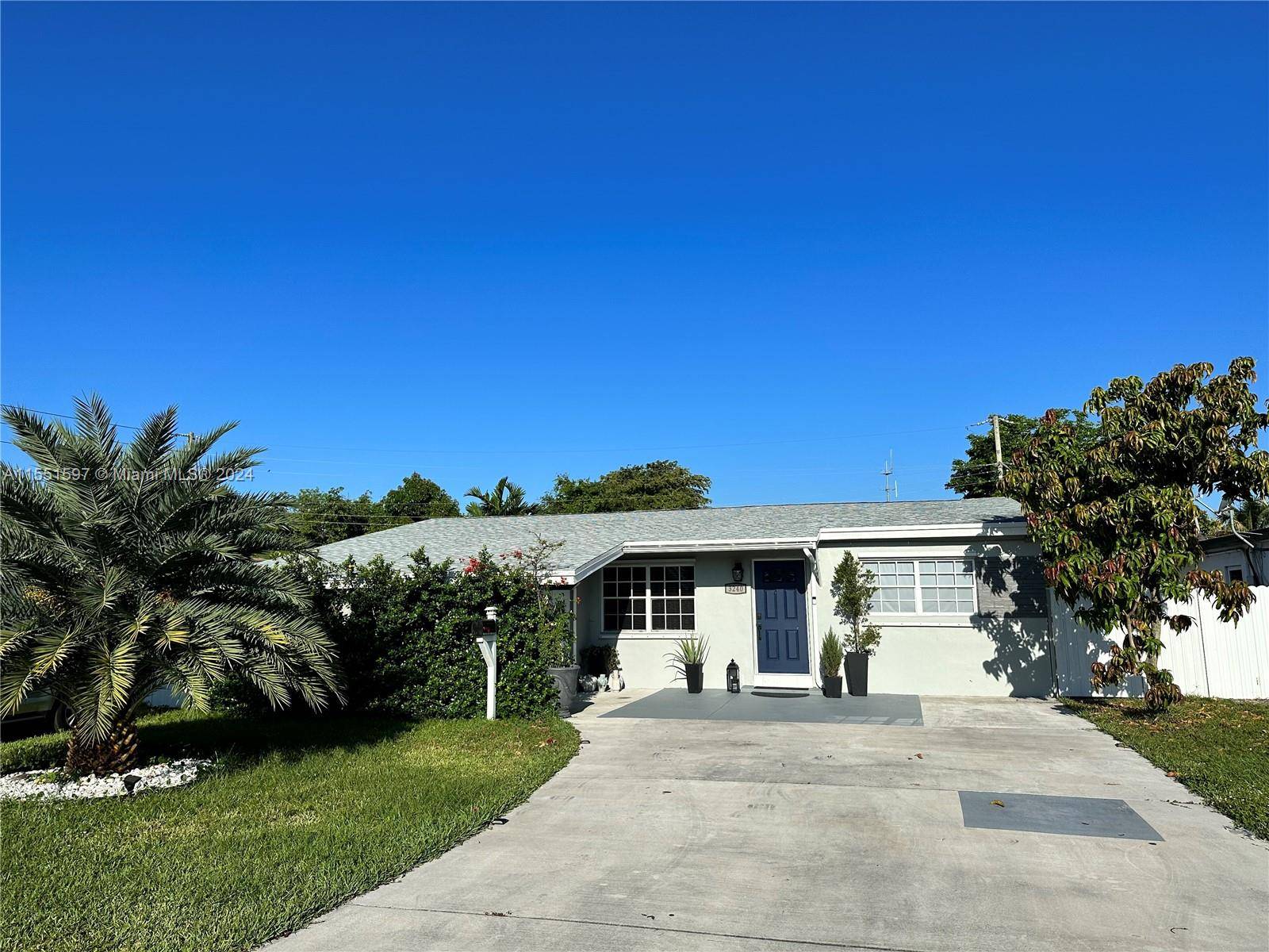 Completely renovated 3 bedrooms and 2 bathrooms home featuring a modern kitchen with beautiful quartz countertops, and white tile backsplash.