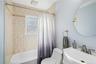 Bathroom with shower / bath combo and vanity
