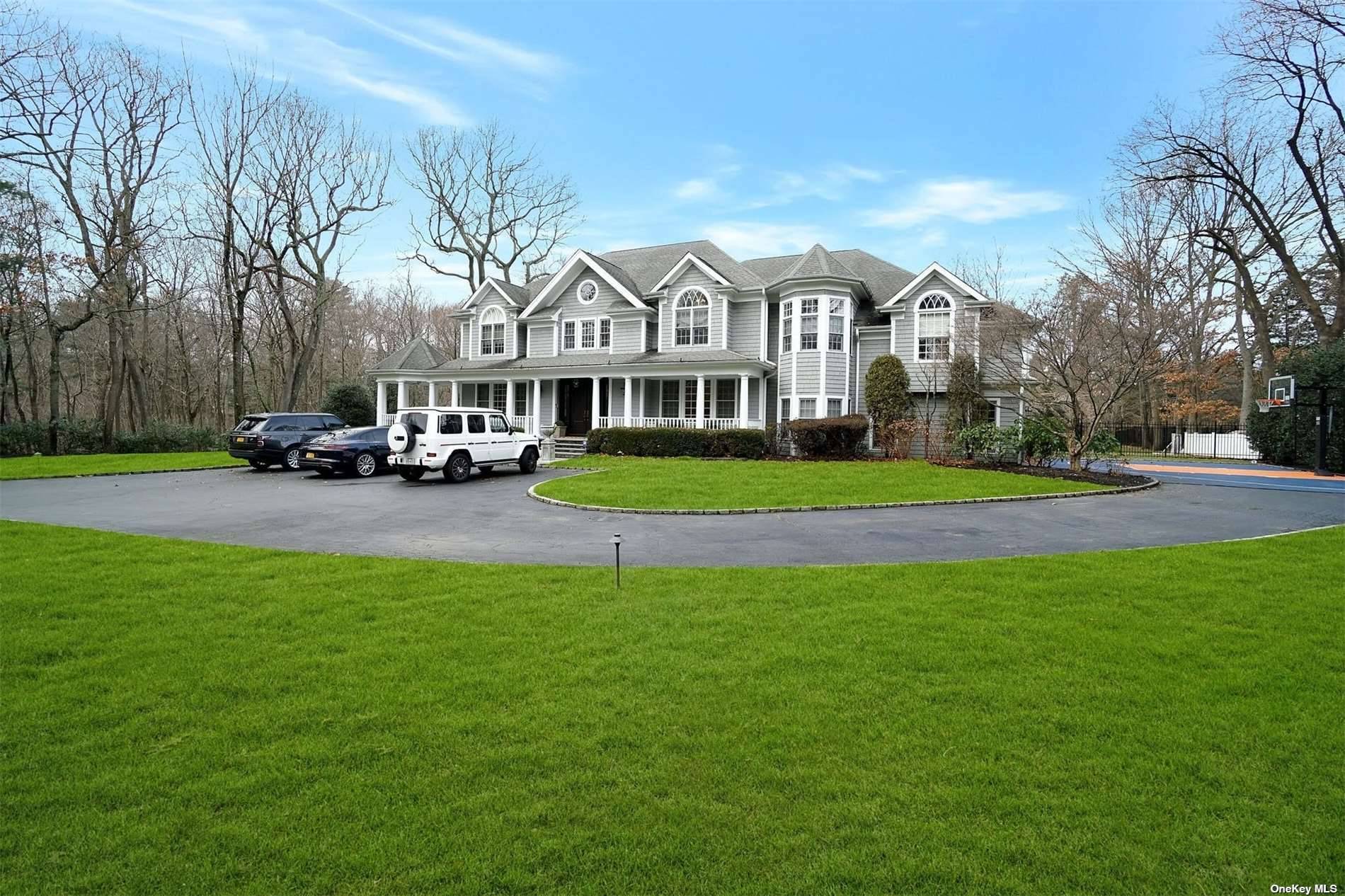 Majestically Situated On The North Shore Of Long Island In The Prestigious Gold Coast Village Of Muttontown, This Impressive Hampton Style Home Sits On Two Plus Park Like Acres.