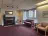 Welcoming and charming waiting room complete with cozy fireplace.