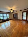 Large Livingroom with hardwood floors and ceiling fan.