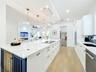 Island with cupboards on each side and wine fridge