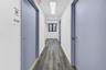 Hall with dark wood finished floors and a skylight