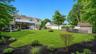 Expansive green lawn with mature perimeter trees