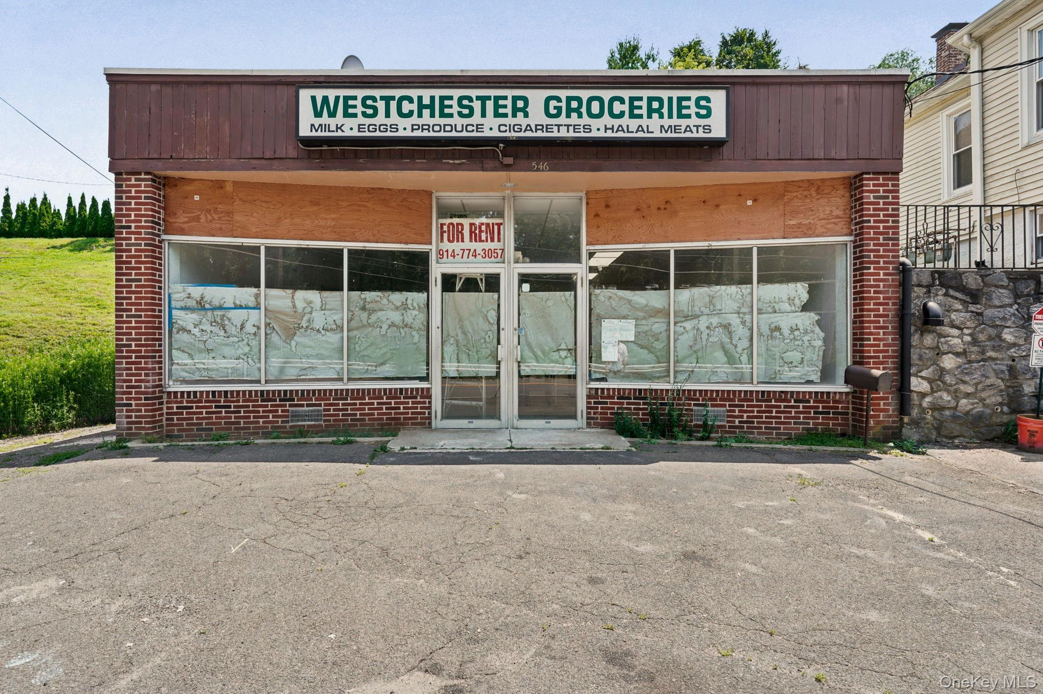 Commercial storefront featuring red brick and large display windows