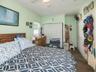 Carpeted bedroom featuring crown molding, a closet, and ceiling fan