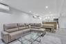 Lower level Open-concept living area featuring light gray walls, recessed lighting, and large format tile flooring