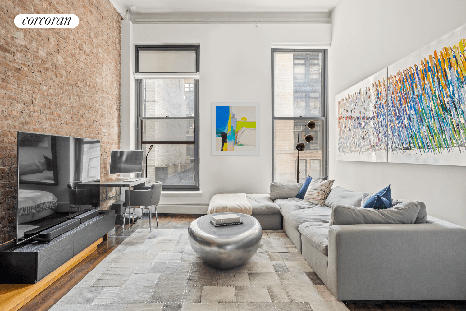 Pre war loft drama meets flawless craftsmanship and interior design at this glamorous residence with soaring 14 foot ceilings and exposed brick on the border of Greenwich Village and Noho.
