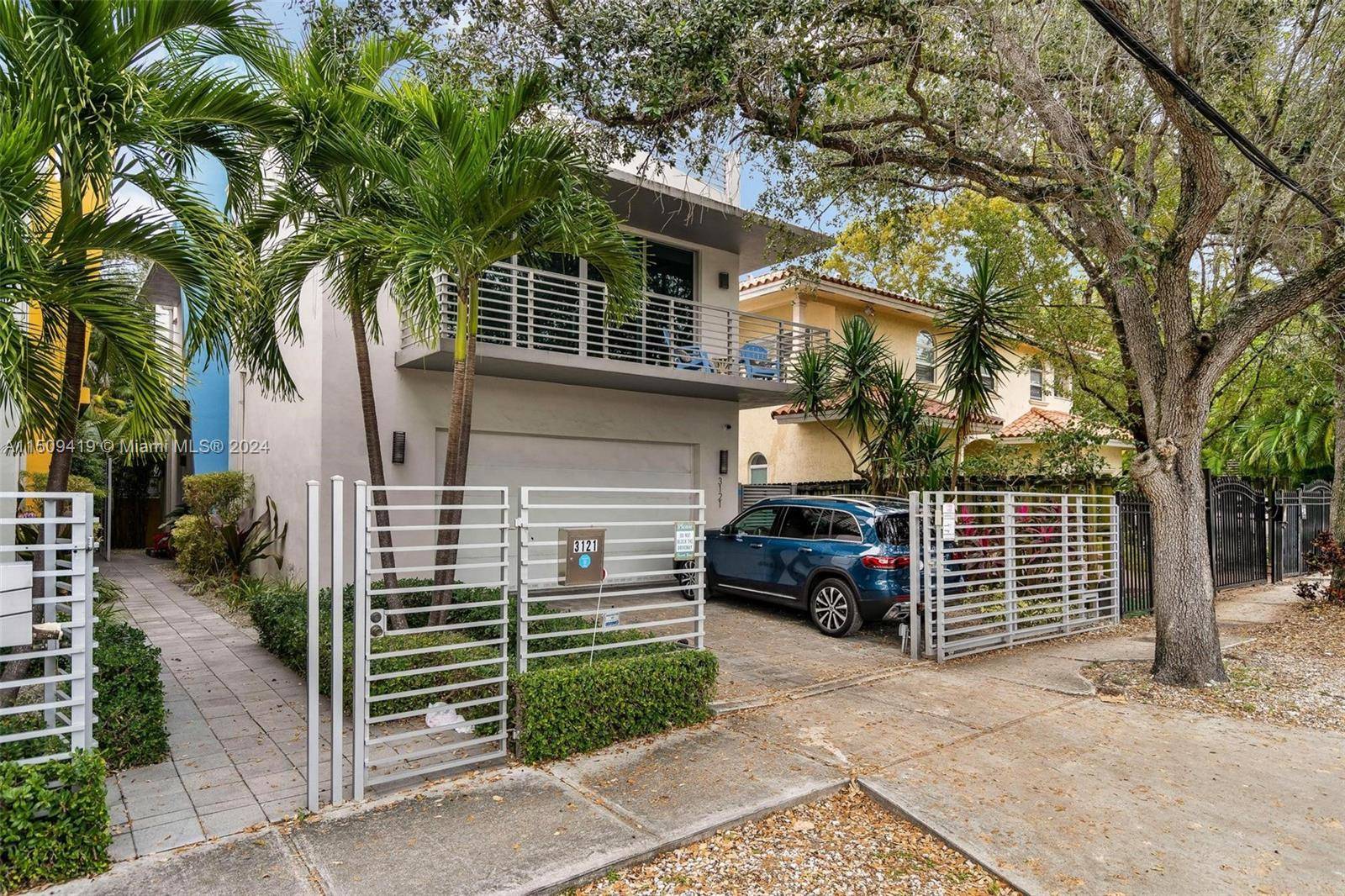 RECENTLY REPRICED UNIQUE PROPERTY Detached townhome in central Coconut Grove location with a rare 2 car garage, pool rooftop.