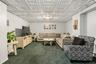 Recessed ceiling with white decorative panels and a central flush-mount light fixture
