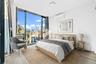 Bedroom with a wall of windows, a wall mounted air conditioner, light wood-style floors, and access to outside
