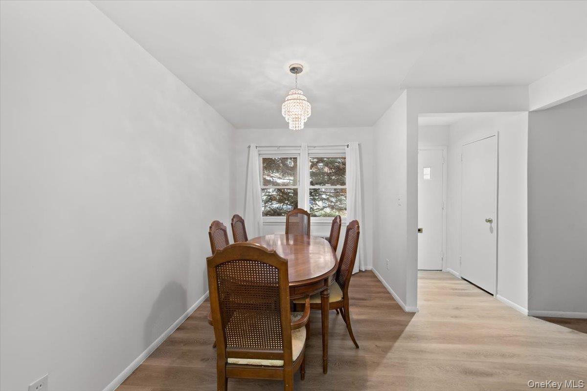 Bright and open dining room with brand new luxury vinyl flooring and freshly painted.