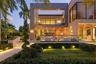Contemporary rear elevation featuring covered outdoor living terrace, wood-ceiling loggia, floor-to-ceiling glass, second-level balcony with pergola,