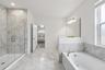 Upgraded en-suite bath includes a soaking tub and separate glass enclosed shower.