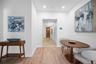 Hall featuring light wood finished floors, baseboards, and recessed lighting
