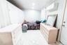 Bedroom with light marble finish flooring and an AC wall unit
