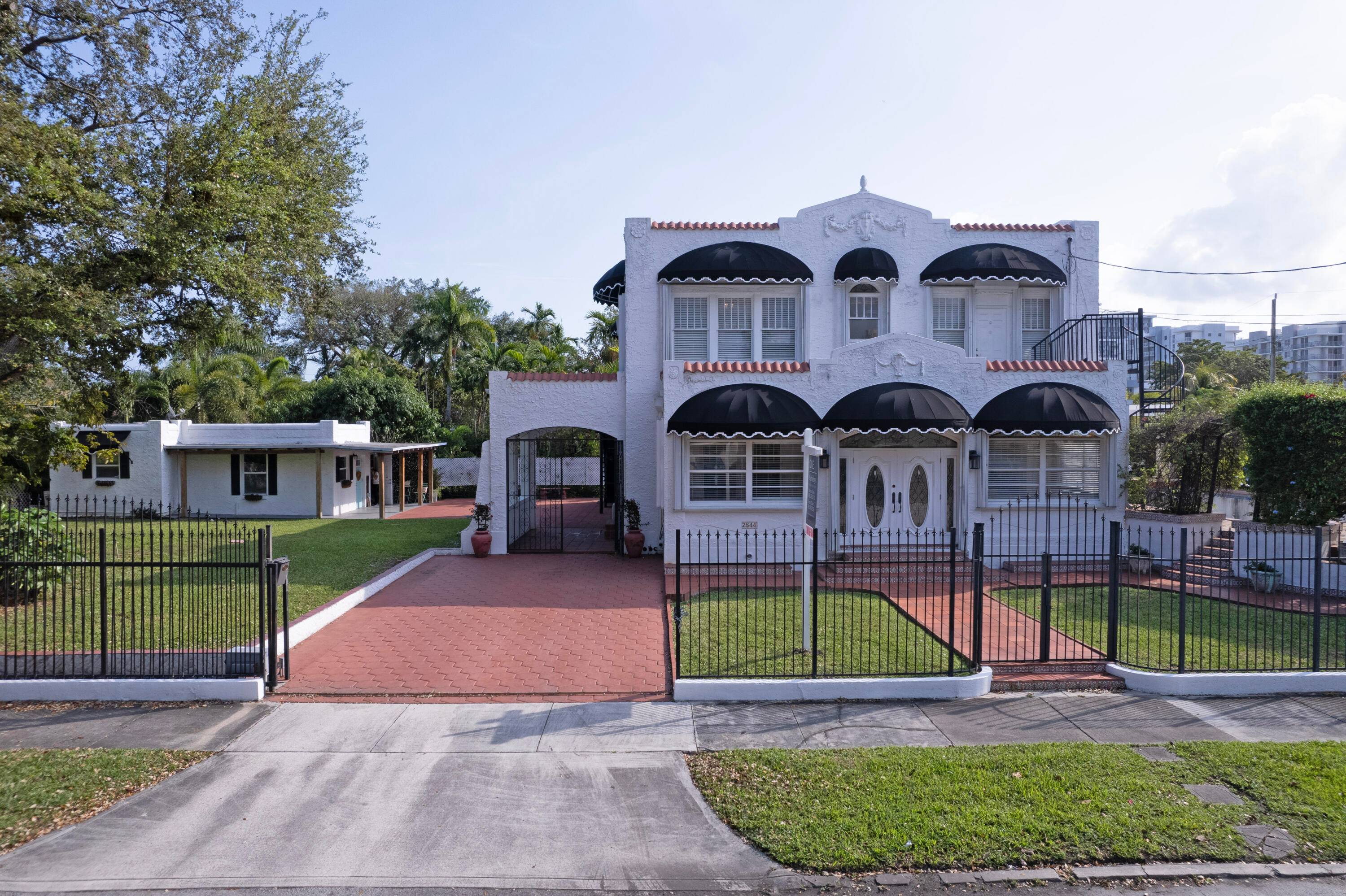 This stunning 1925 Mediterranean home in the heart of Silver Bluff boasts 5 bedrooms, 4 1 2 bathrooms, a guest house, and a pool.