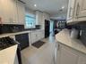 Recently renovated kitchen with quartz countertops and tons of storage.
