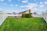 Fenced backyard featuring a wooden deck