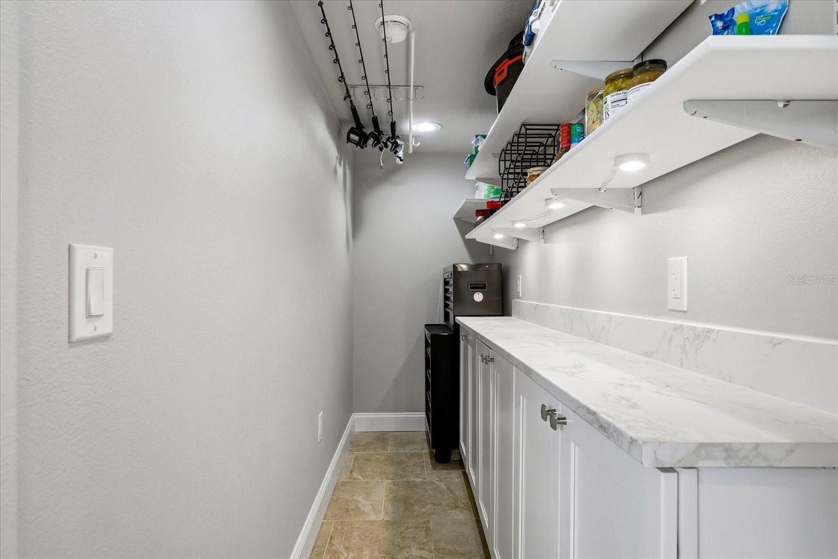 Custom Pantry with Fishing Rod Storage and Room for Tools