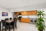 Kitchen area featuring wood cabinetry, stainless steel appliances, and a double basin sink