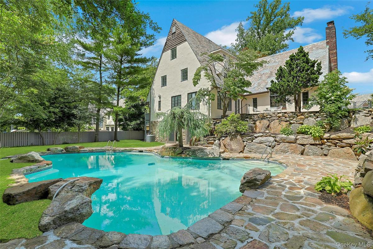 Resort-style living awaits at this spectacular, freshly renovated Tudor with an expansive, recently updated saltwater pool in the heart of the Edgemon