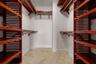 Primary bedroom walk in closet
