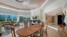 Open great room with adjoining dining area leading to a distinctive circular kitchen design.