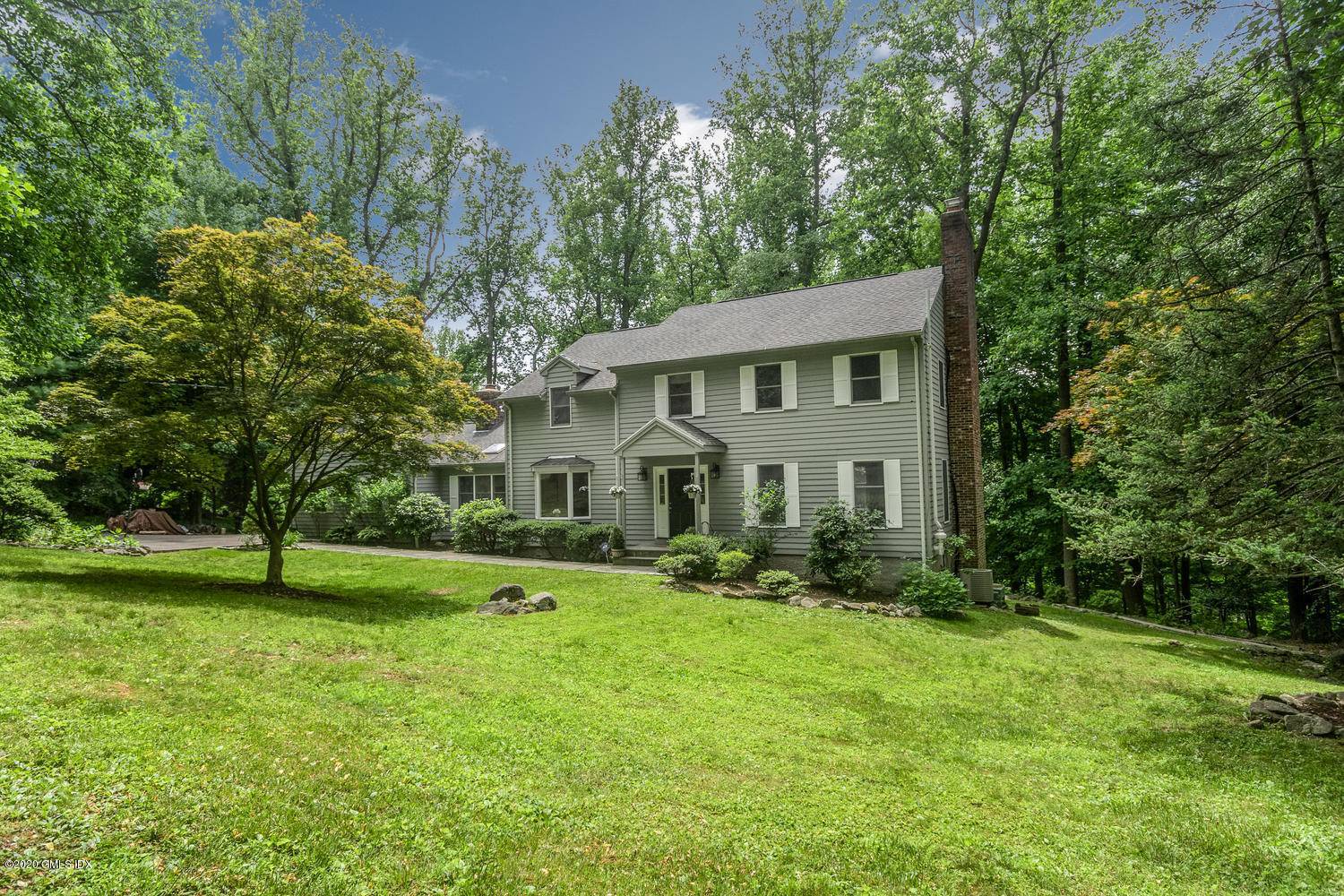 Move right in. Exceptional turn key North Stamford colonial in serene private setting on over 2 acres.