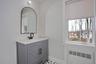 Bathroom featuring radiator, vanity, and a residential view