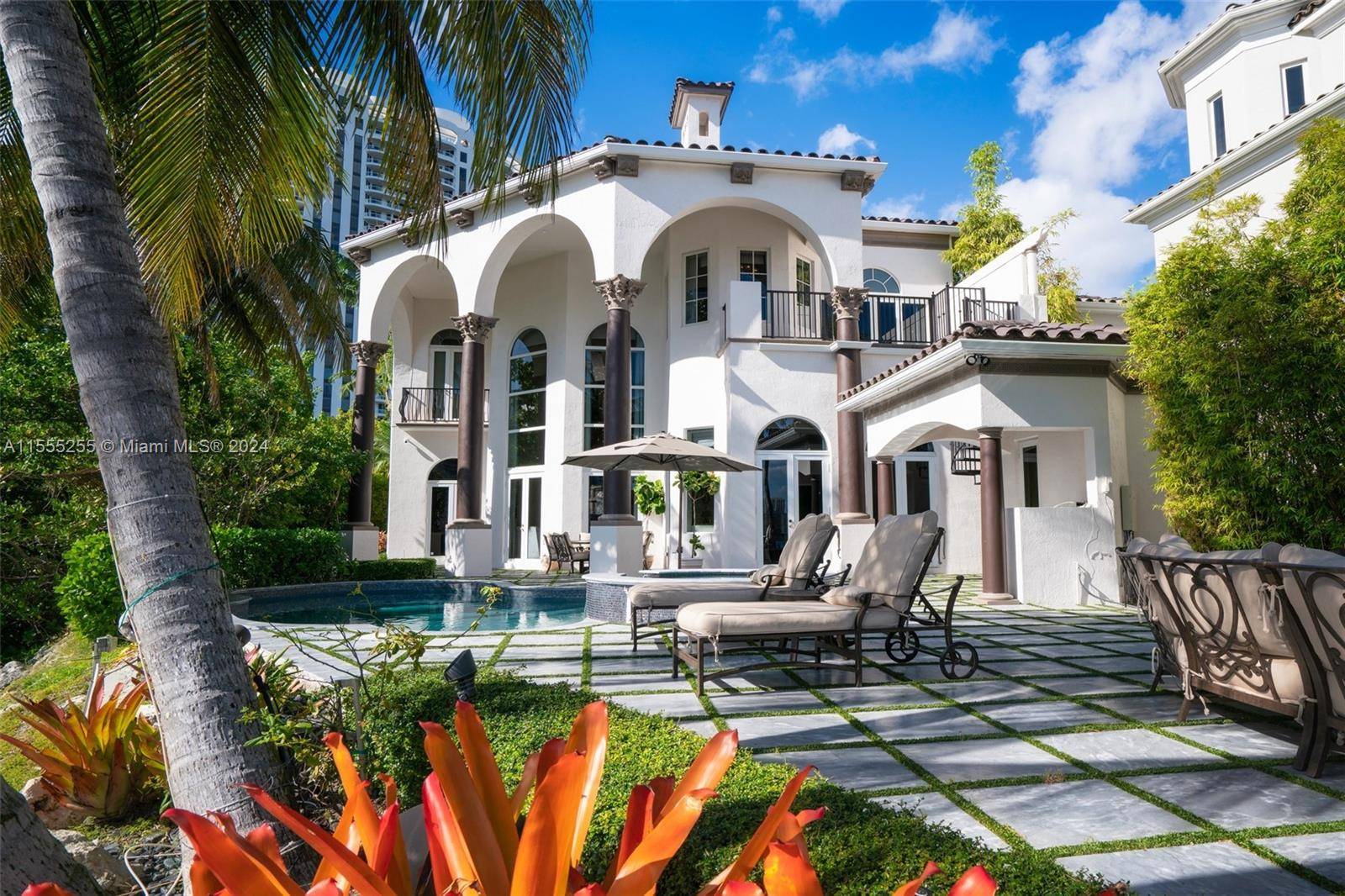 Own a former celebrity bayfront three story Mediterranean estate in the prestigious gated community of Island Estates.