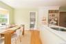 Eat in area of kitchen with bay window and looking towards laundry area and door to patio and backyard