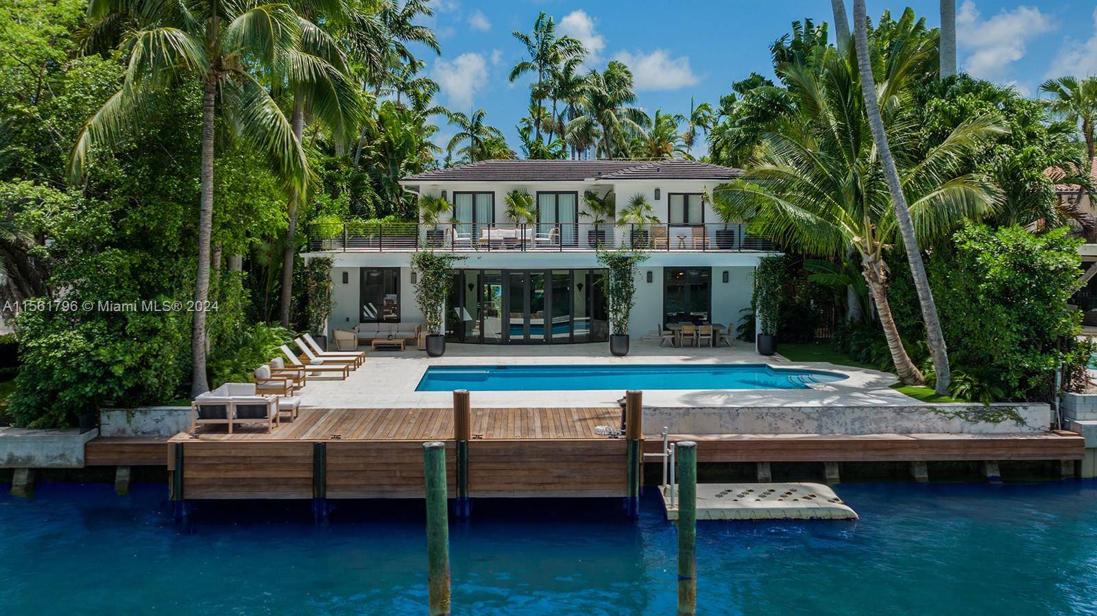 Located on a prime waterfront lot on Miami Beach s exclusive and gated Sunset Island 3, with direct bay access and yacht dockage, this impeccably restored home has been designed ...