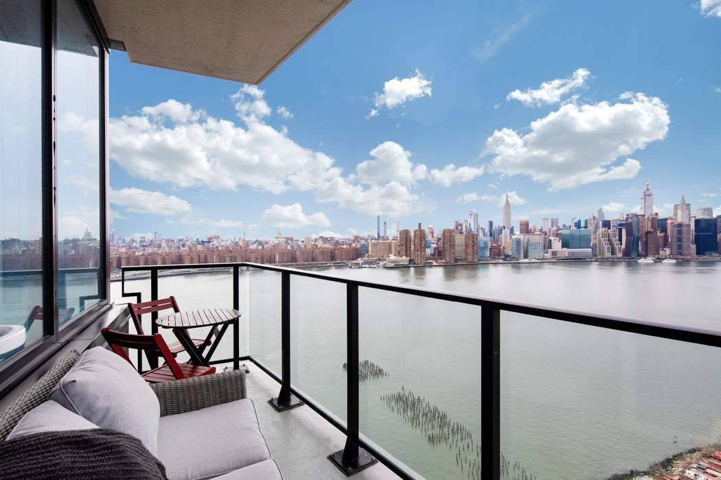 High floor corner residence with private balcony, impeccable finishes, and wraparound windows that frame unobstructed river views.