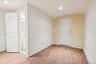 Lower level room with entrance to one of the 2 garages
