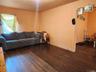 Living room with dark wood-type flooring
