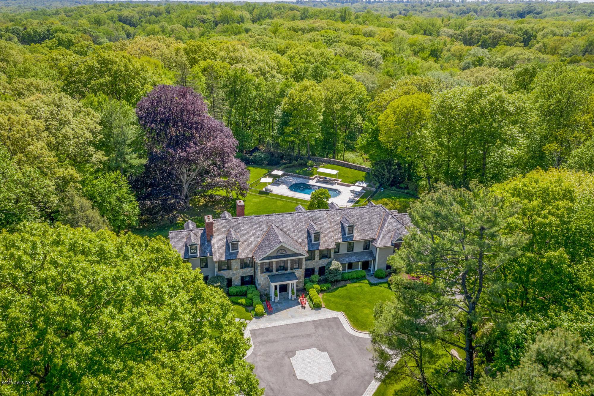 Four beautiful acres with lush sweeping lawn surround this majestic Georgian Colonial available for purchase fully furnished.