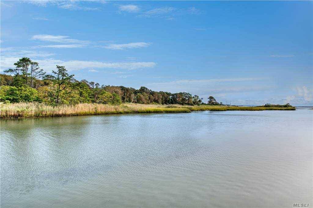 Secluded waterfront home located in a private community south of the highway.