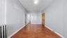 Hallway featuring radiator heating unit and dark wood finished floors
