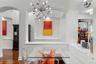 Dining area with architectural detail and updated chandelier.