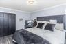 Bedroom featuring wood-finish flooring, crown molding, and a contemporary ceiling light fixture