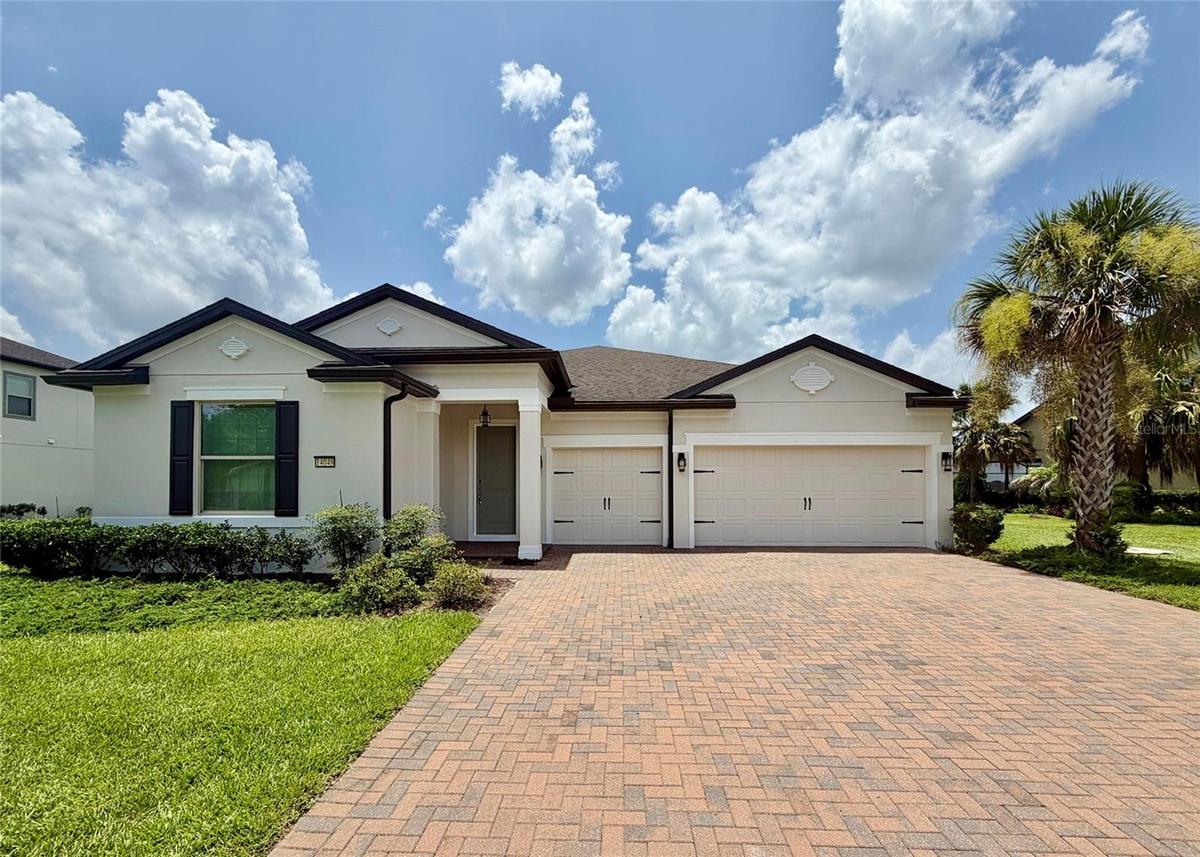 14048 Larkspur Lake Dr - Front exterior with three-car garage and spacious driveway.