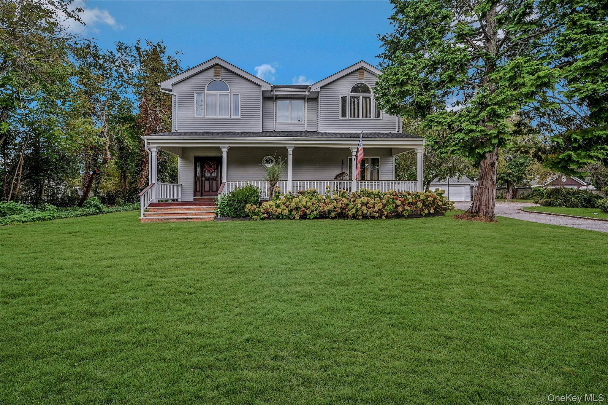 Discover the rare opportunity to live year round in the heart of South Jamesport, on one of the largest lots in the area an expansive 1.