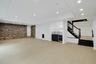 The extraordinary walk-out lower level offers exceptional space for recreation and entertaining, featuring a built-in kitchenette with bar sink and be
