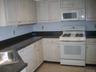 Kitchen with gas stove, dishwasher, and plenty of storage space.