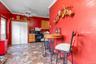 Kitchen with ceiling fan, black appliances, and ornamental molding