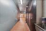 Hallway featuring light tile patterned flooring and a sink