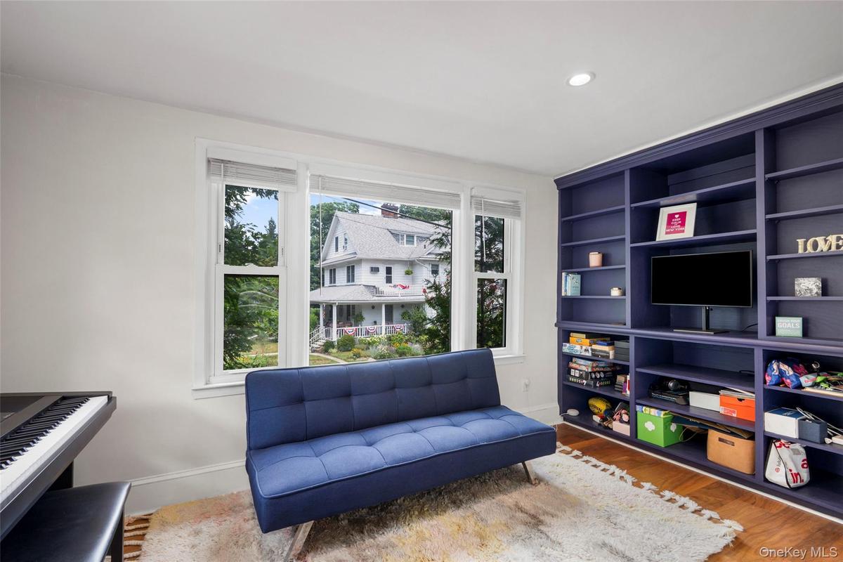 Full wall of built-in shelving with an integrated media console.