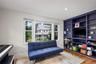 Full wall of built-in shelving with an integrated media console.
